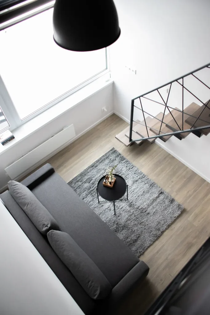 Overhead view of a pale interior with an open stair