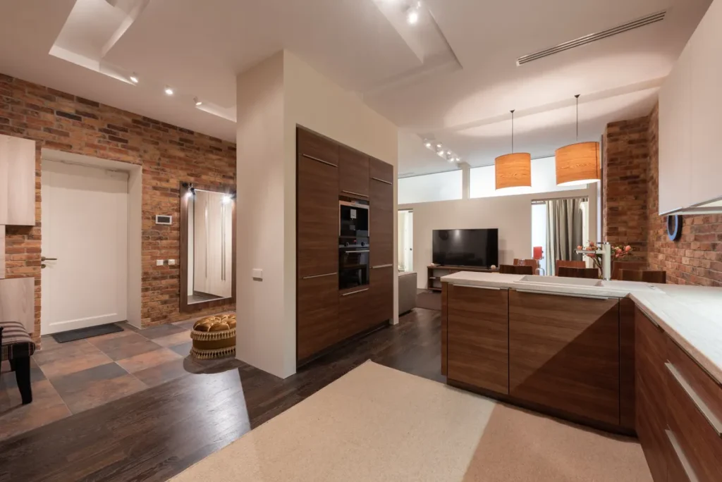 Open kitchen and living space with daylight from a tall window