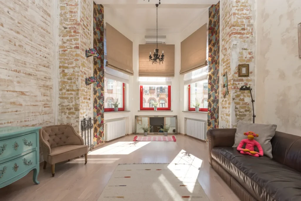 Quiet room with louvred window light falling across a plaster wall
