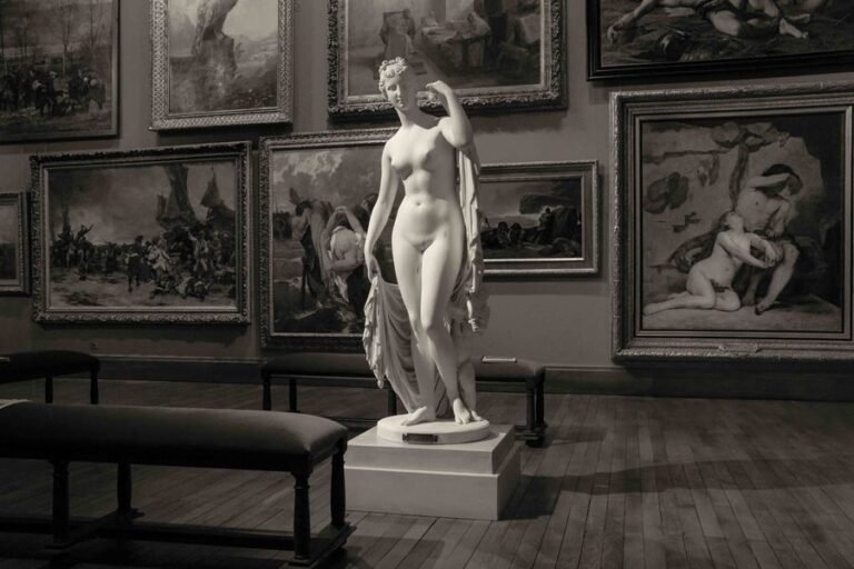 A marble sculpture on a plinth in a museum room