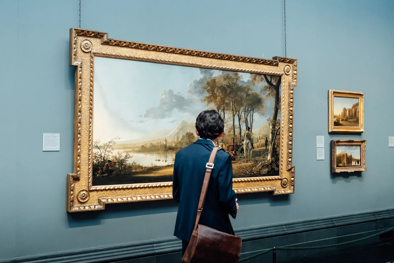 A visitor studies an Old Master painting in the viewing gallery