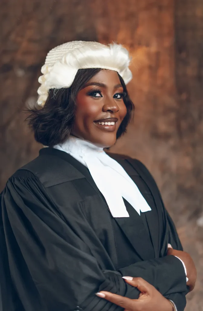 Barrister in traditional court attire smiling in chambers