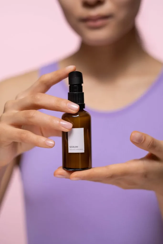 Woman holding a skincare serum bottle