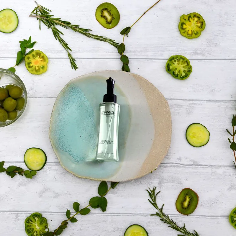 Natural skincare serum with cucumber slices and herbs