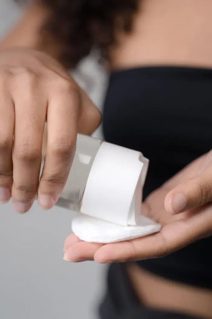 Pouring toner onto a cotton pad