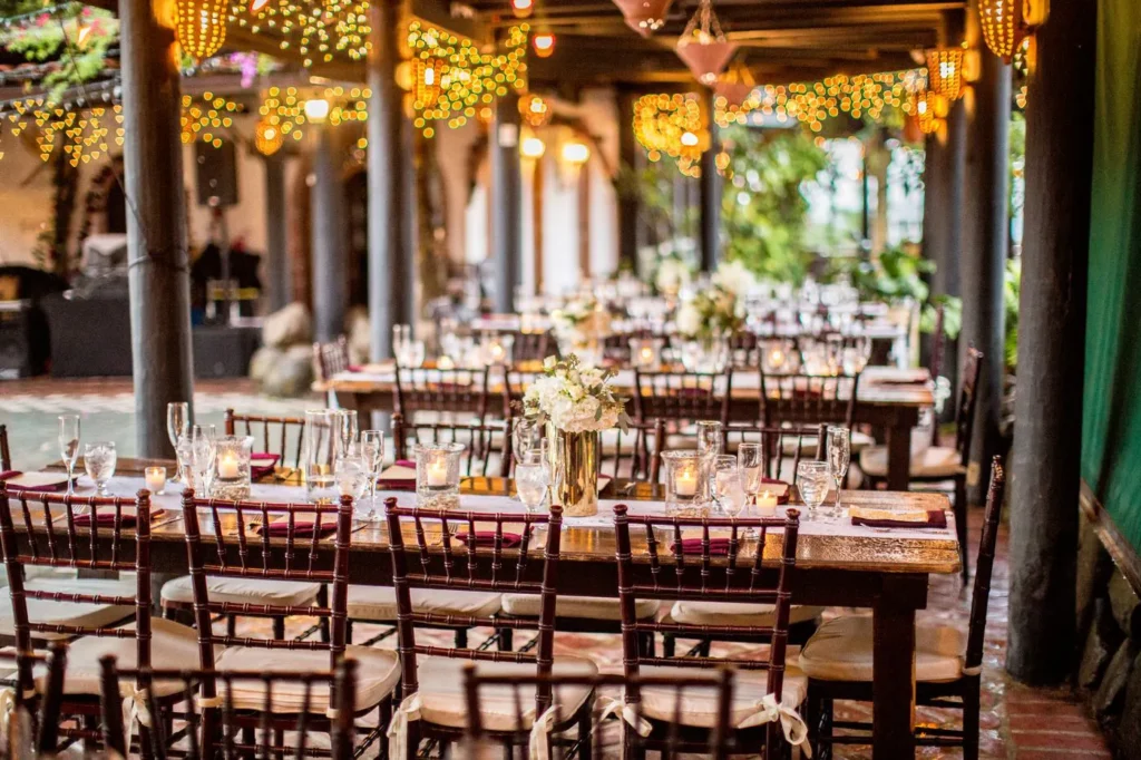 Outdoor dinner table under warm bistro lights