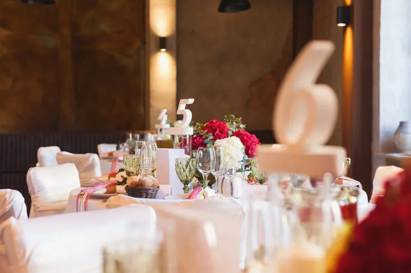 Tables with floral centerpieces and table numbers