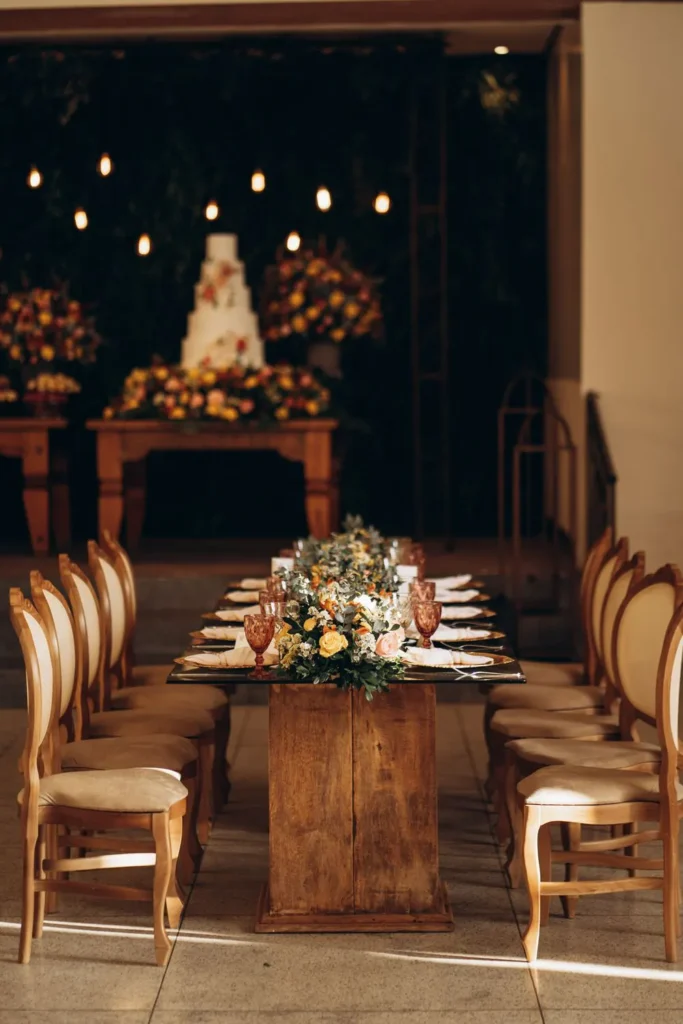 Reception table with florals and a tiered cake