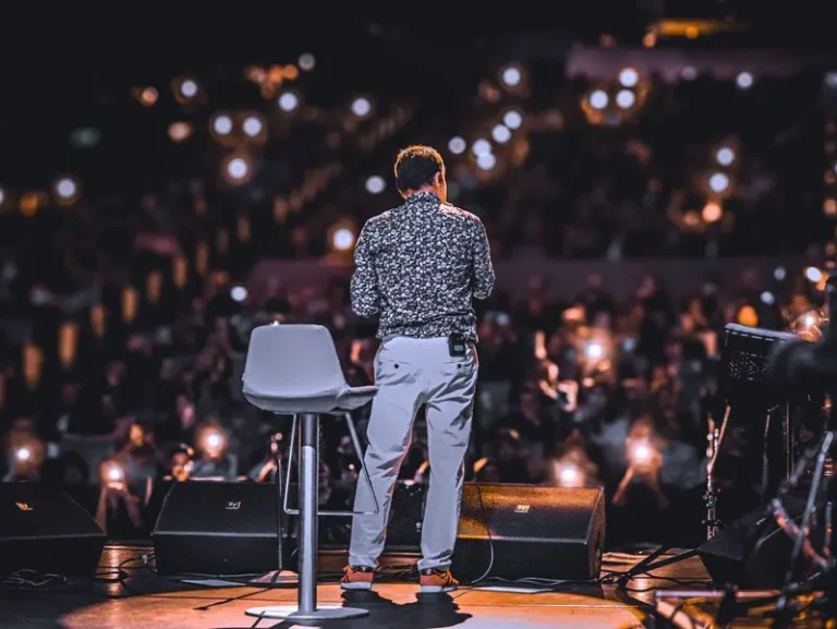 Speaker on stage facing a large audience