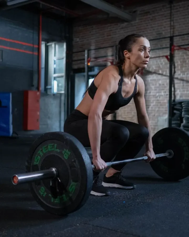 Woman preparing to lift a barbell in the gym