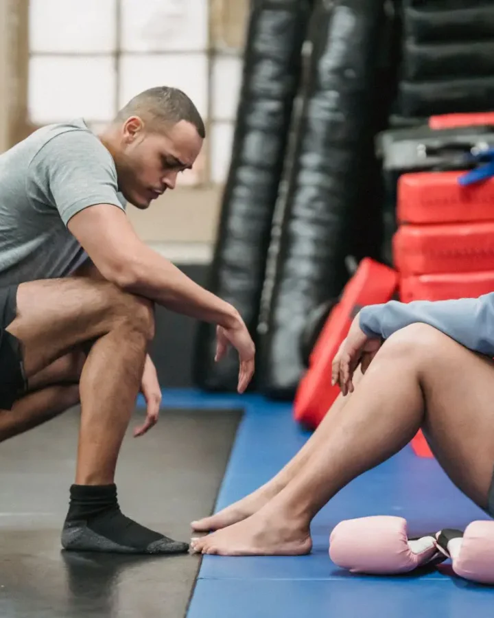 Personal trainer coaching a client during a boxing workout