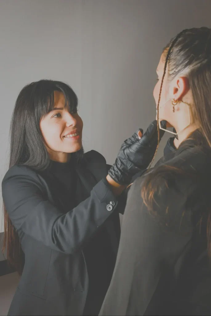 Stylist adjusting a client's hair in the salon