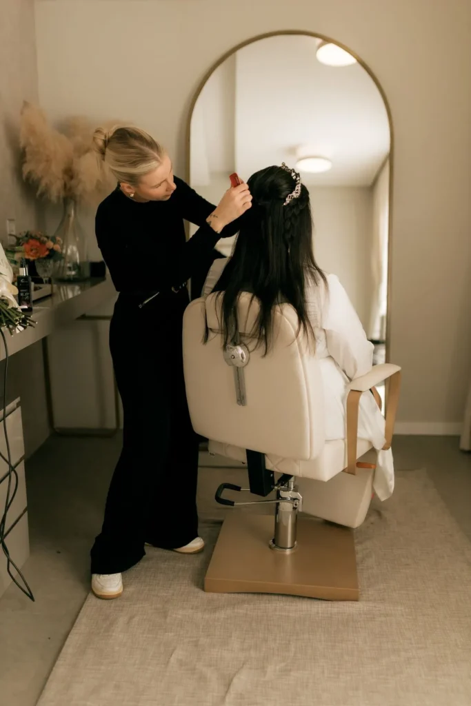 Stylist adding flowers to a bridal updo