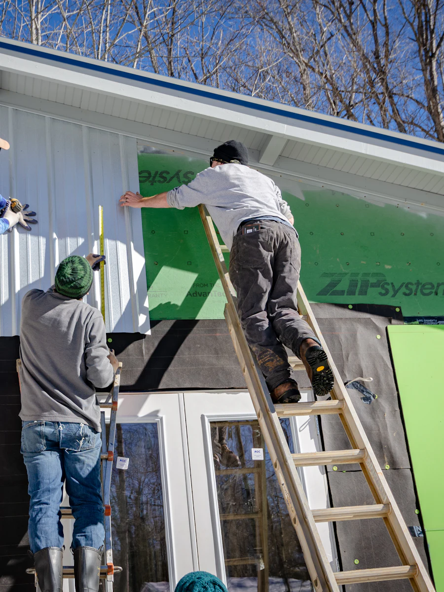 Crew members working against a new build exterior