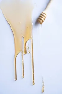 Honey flowing from a dipper
