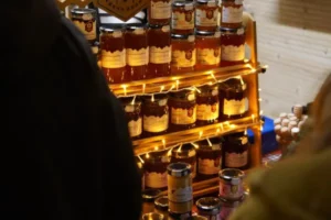 Honey jars lit with fairy lights at a market