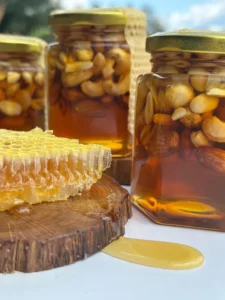 Honey with nuts in glass jars