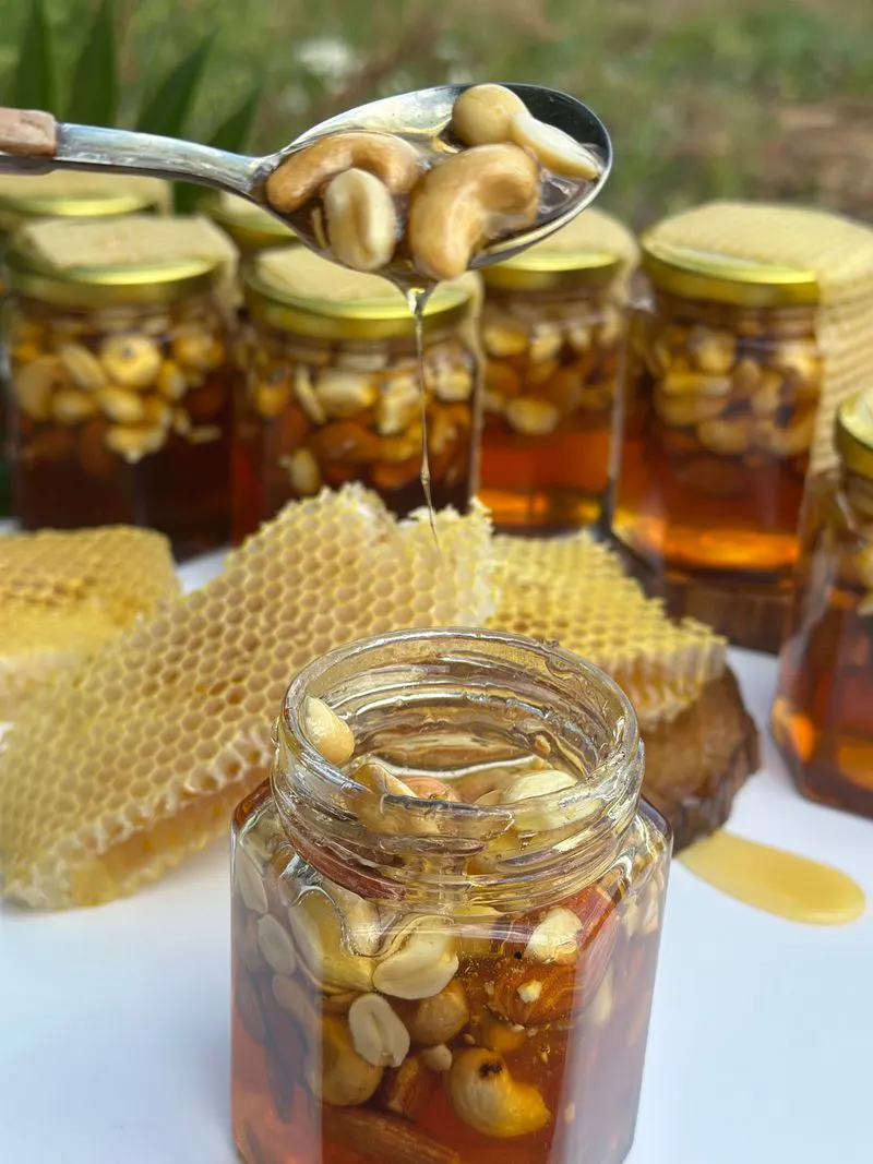 Jars of honey and nuts with honeycomb
