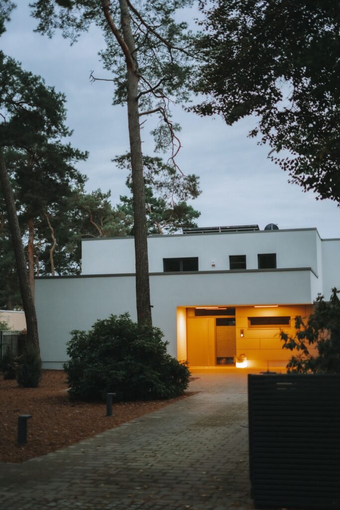 Pinewood Pavilion, a house with a glowing entrance among pines