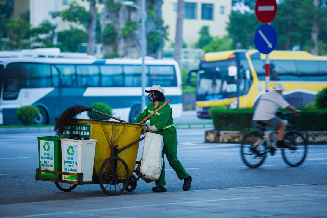 Operator moving recycling bins on a collection round