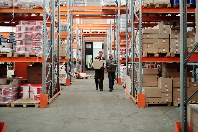 Workers in a warehouse aisle