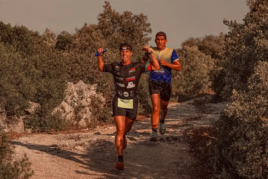 Two runners sharing a joyful moment during the race