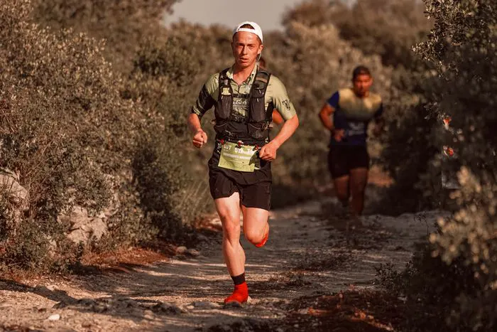 Two runners on a rugged footpath
