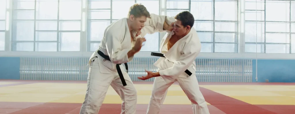 Adults sparring in karate uniforms