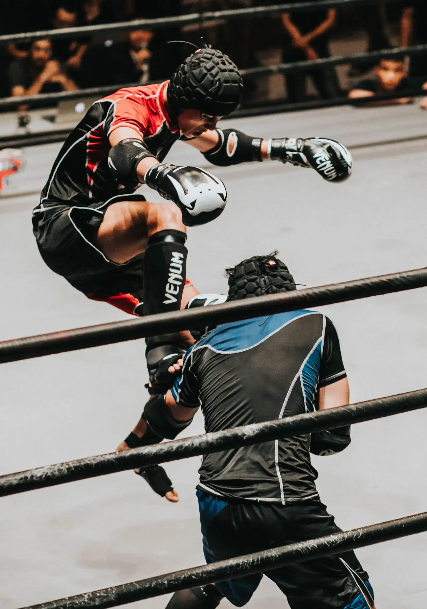 Boxer training in a dark gym
