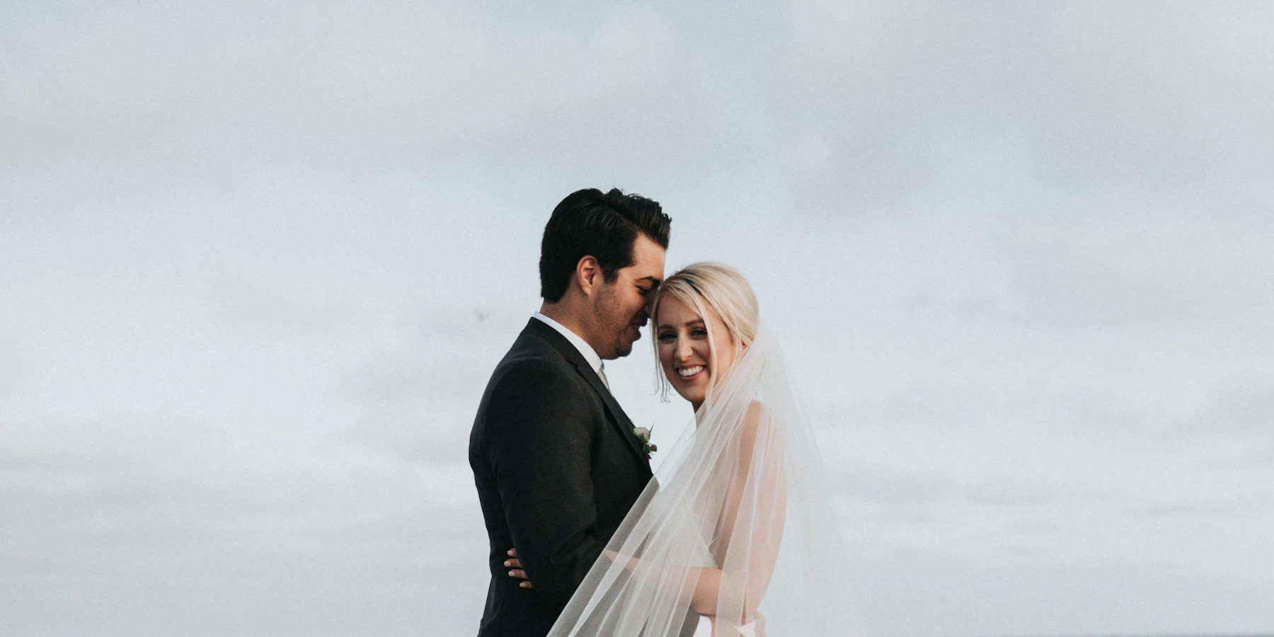 Wedding couple embracing outdoors