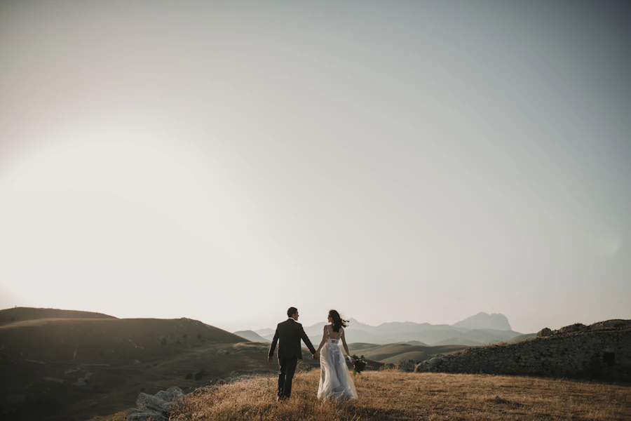 Couple walking hand in hand across the hills