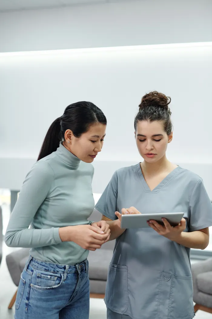 Doctor and patient reviewing a tablet