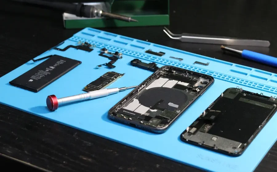 Smartphone parts laid out on a repair mat