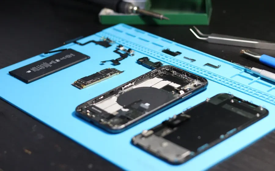 Disassembled smartphone with repair tools