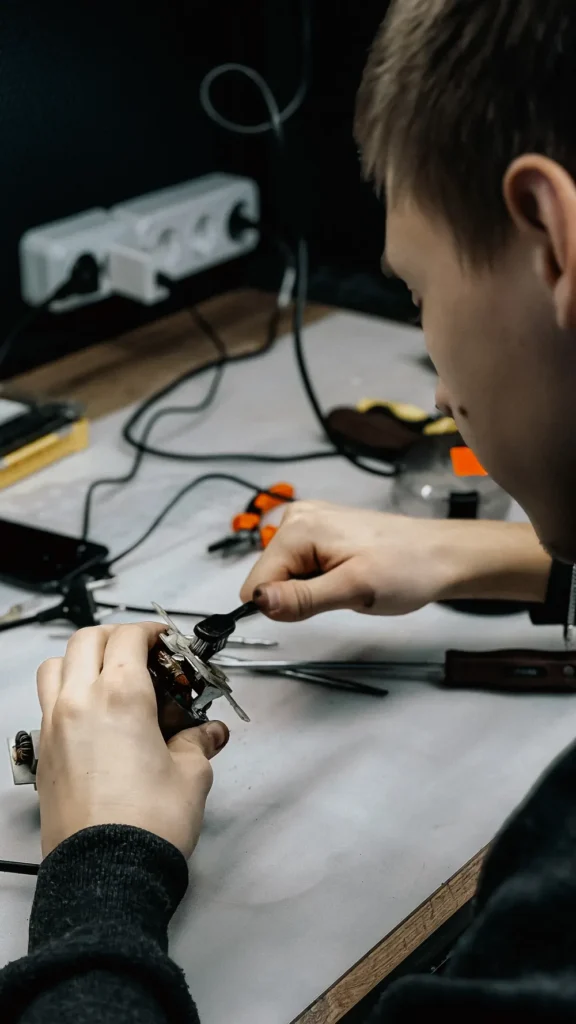 Young technician repairing an electronic device