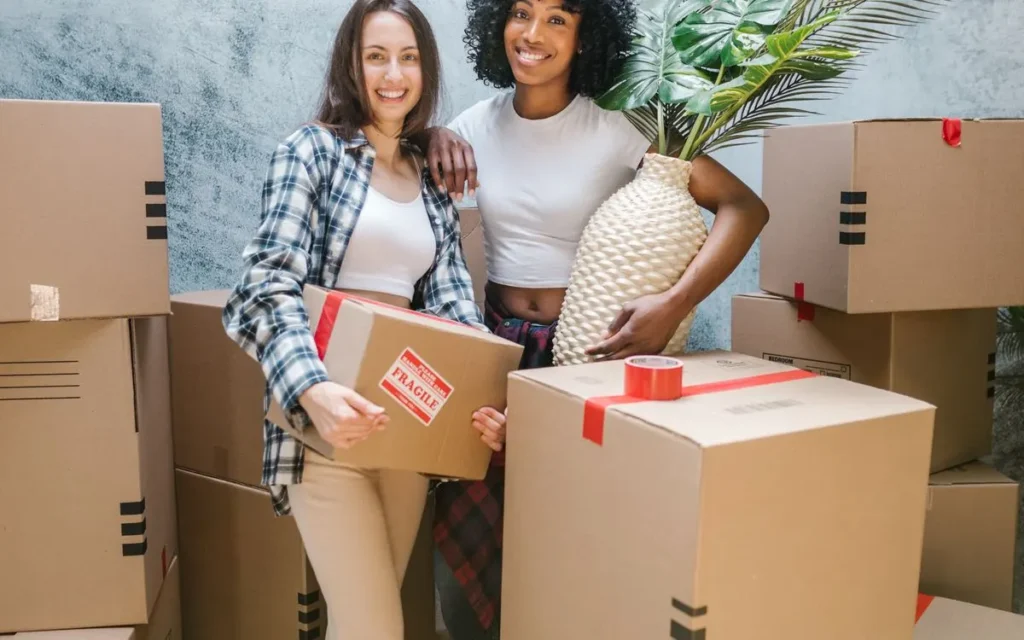 Couple packing moving boxes at home