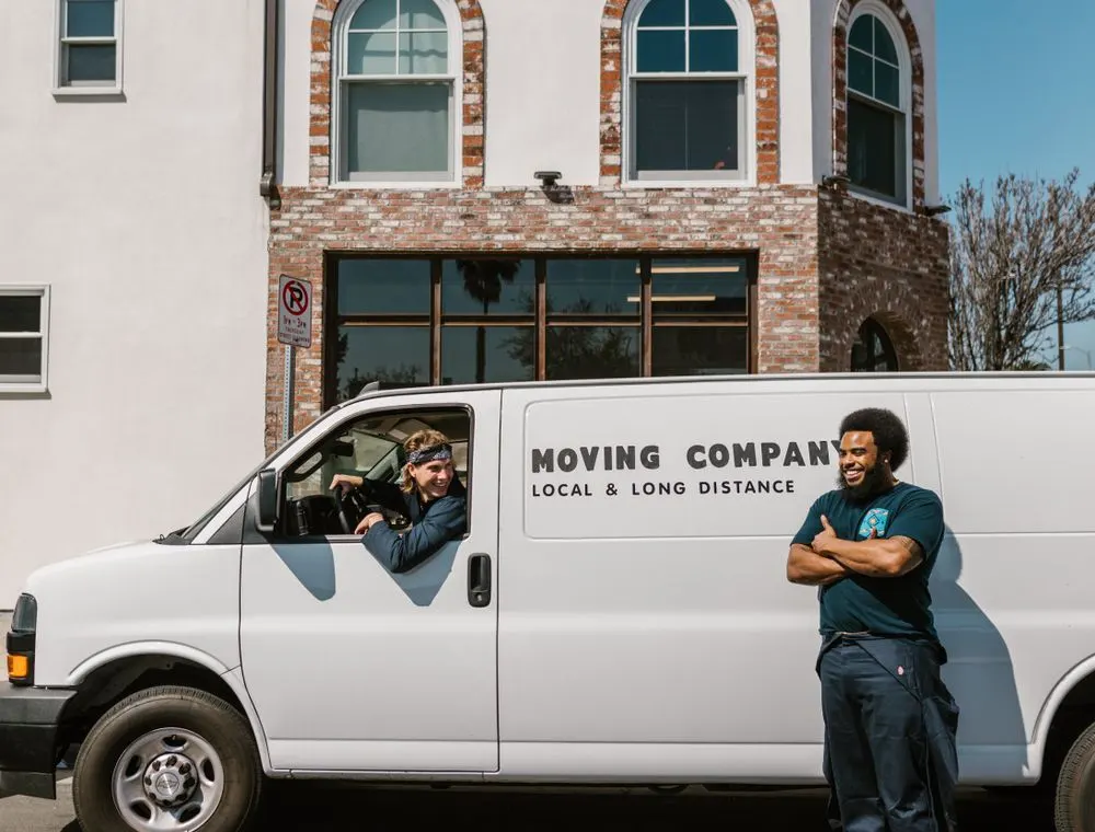 Moving crew standing beside their van