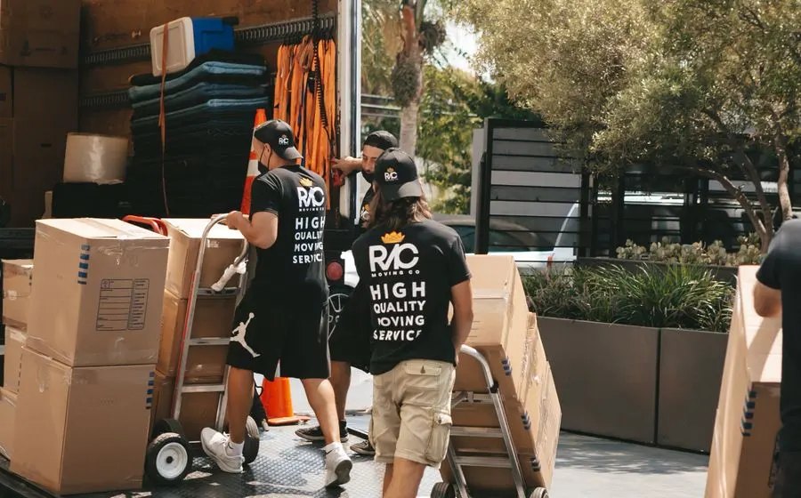 Movers loading boxes into a truck