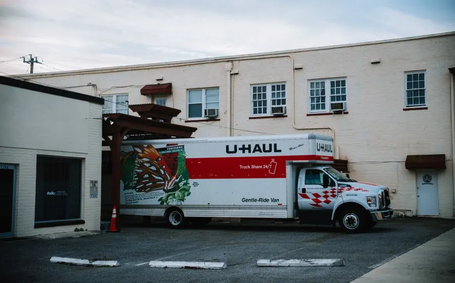 Moving truck parked by a warehouse