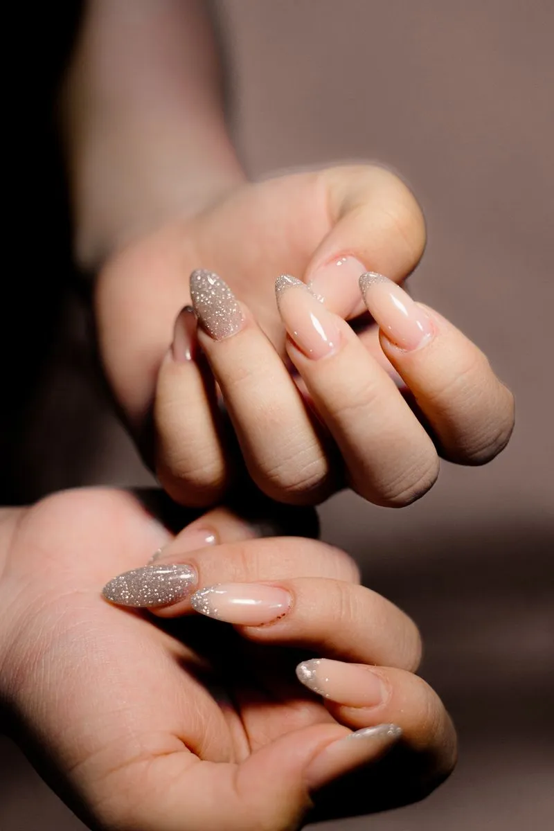 Nude manicure with glitter accent nails