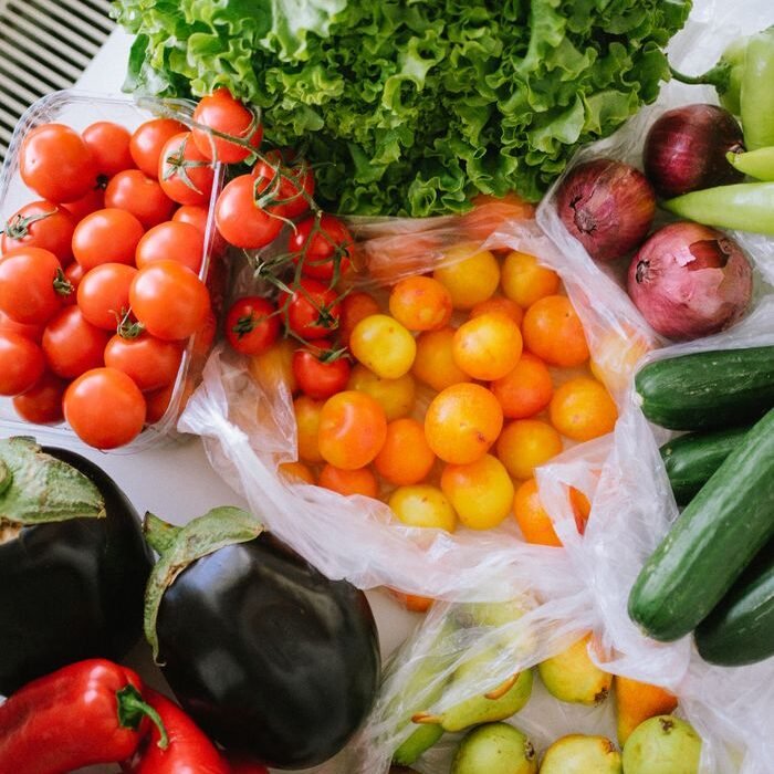 Assortment of fresh tomatoes, peppers, cucumbers and lettuce
