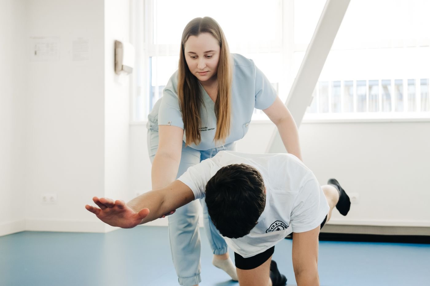 Physiotherapist assisting a patient with stretching exercises