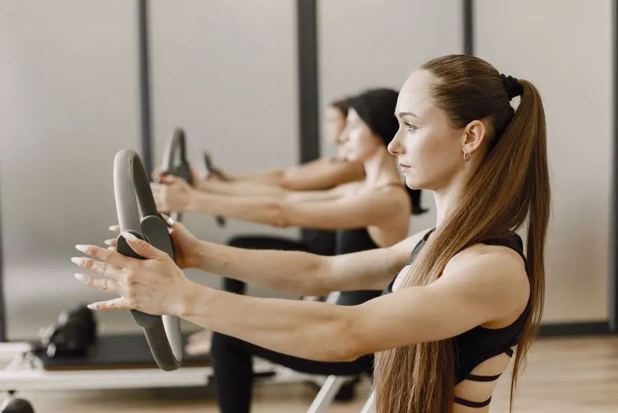 Women practising Pilates with magic rings