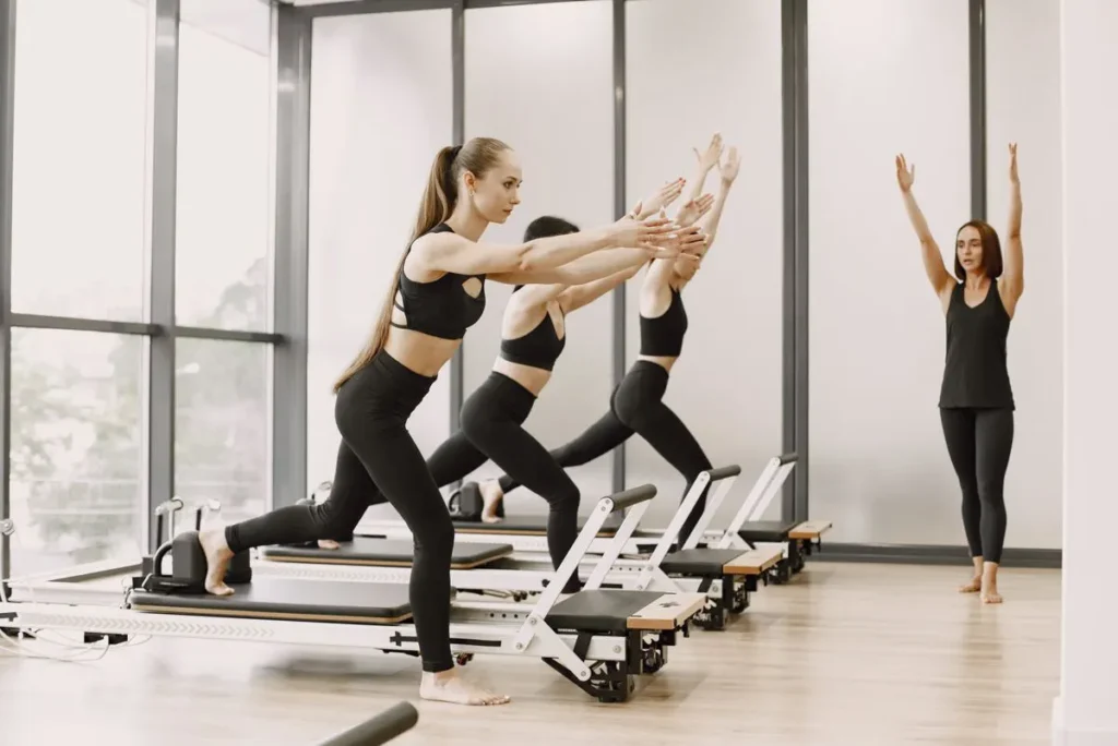 Reformer Pilates class in a bright studio