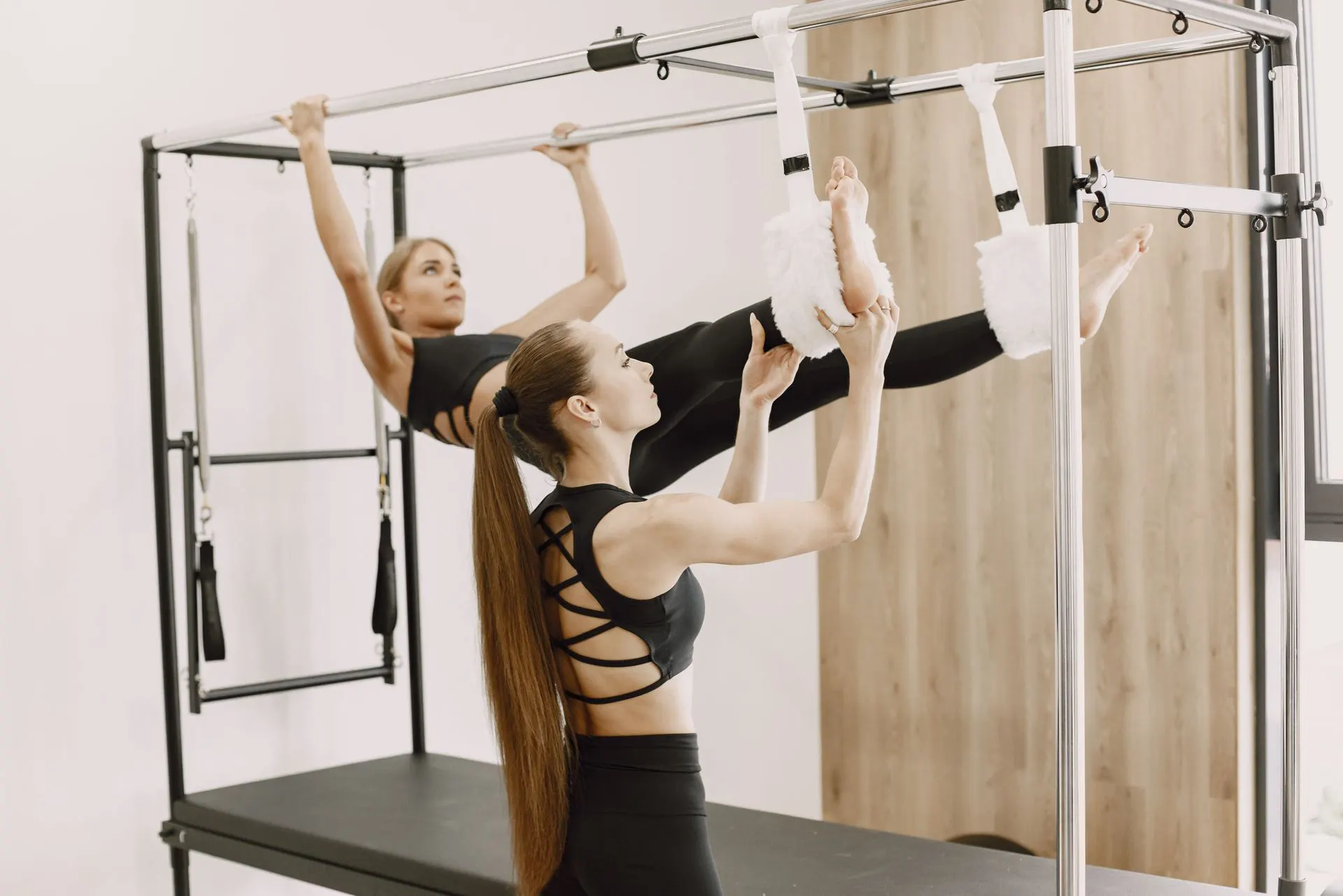 Pilates class stretching on reformers