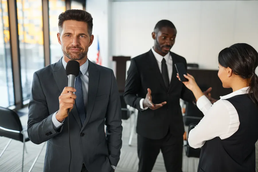 A journalist interviewing an executive in a conference room