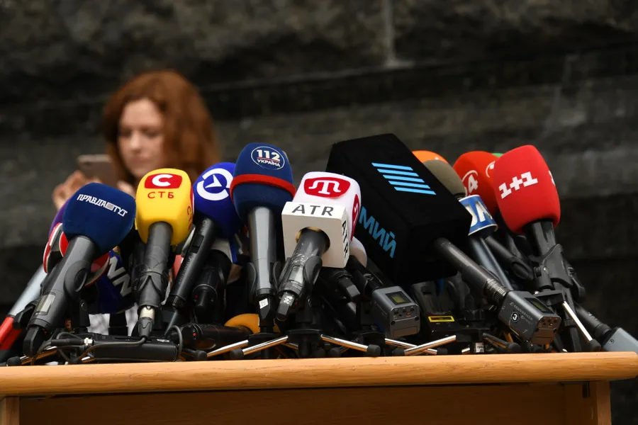 Microphones arranged on a table before a press conference