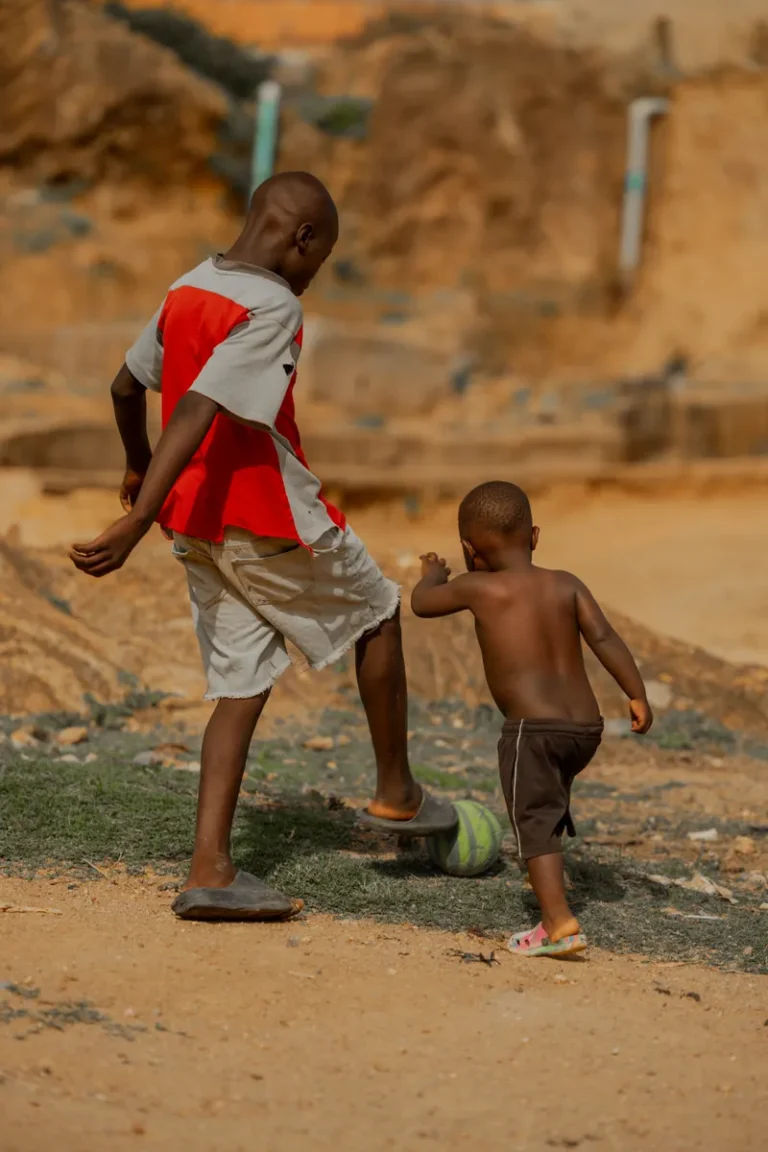 Children playing soccer outdoors