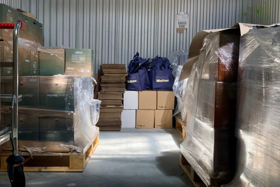 Stacked cartons and sacks on shelving inside a warehouse