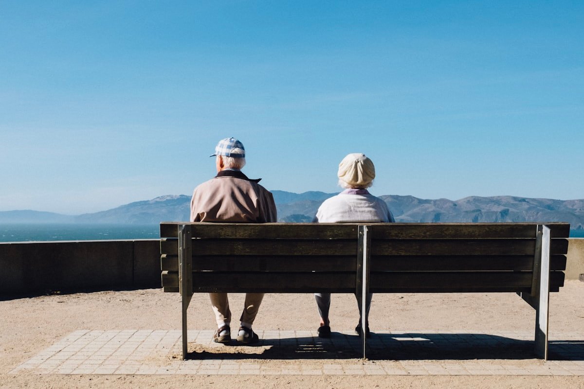 An older couple looking out over the sea